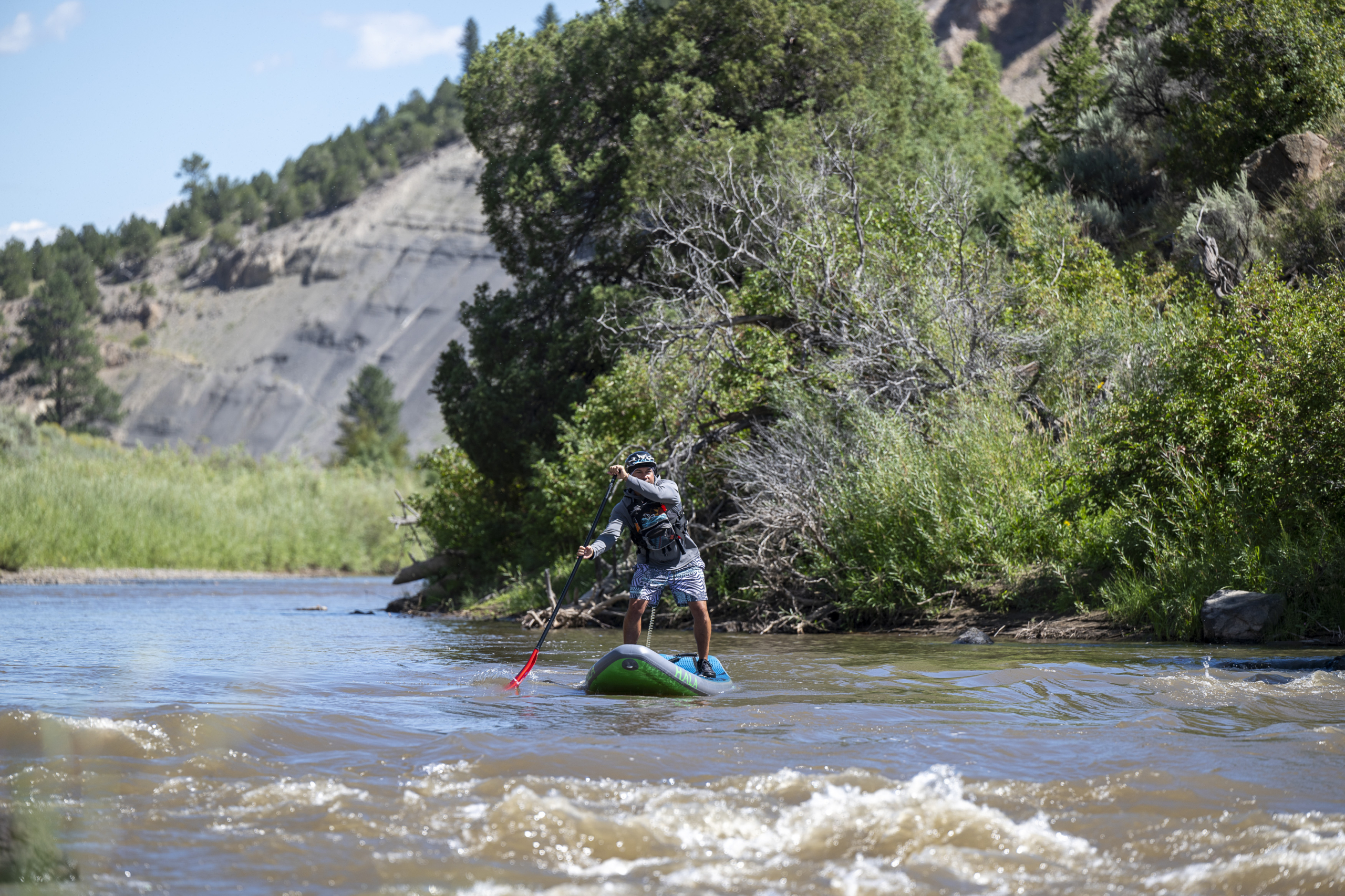 Kayaks and paddle boards at Dillon Marina dock on a sunny Colorado summer morning with mountain backdrop