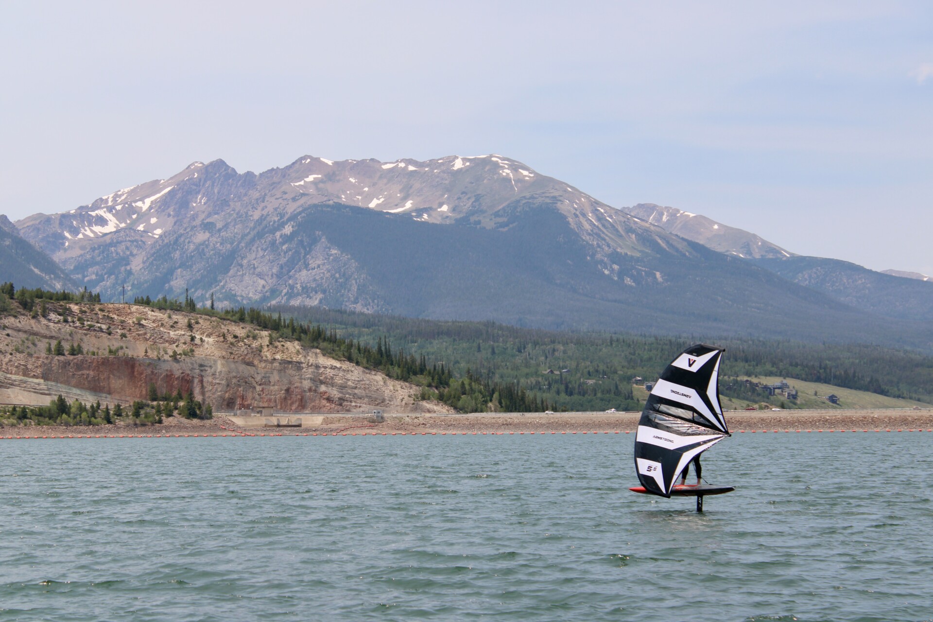 Lake Dillon foil lesson with wingfoiling rider and mountain backdrop