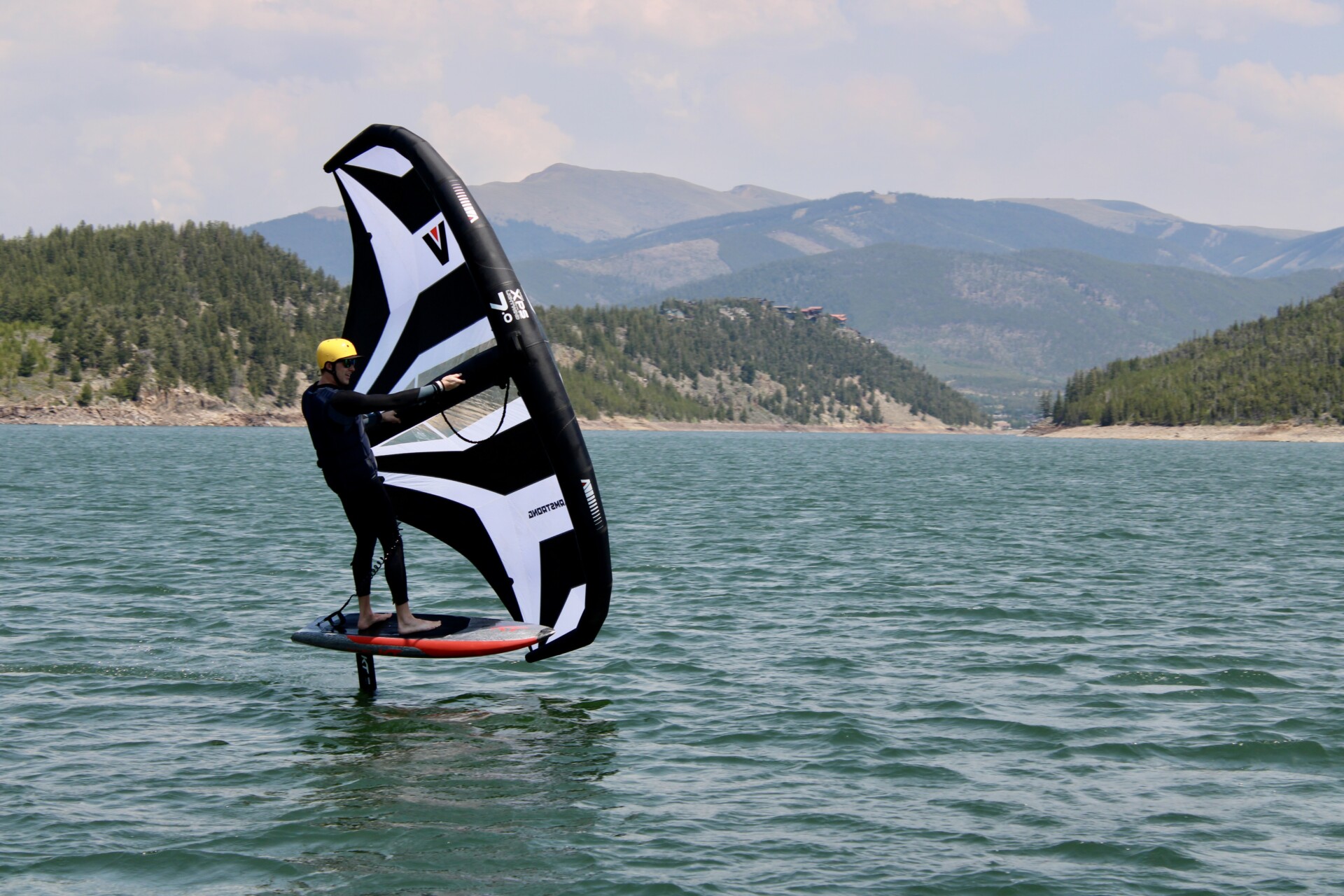Foiling rider gliding with wing during Colorado lesson