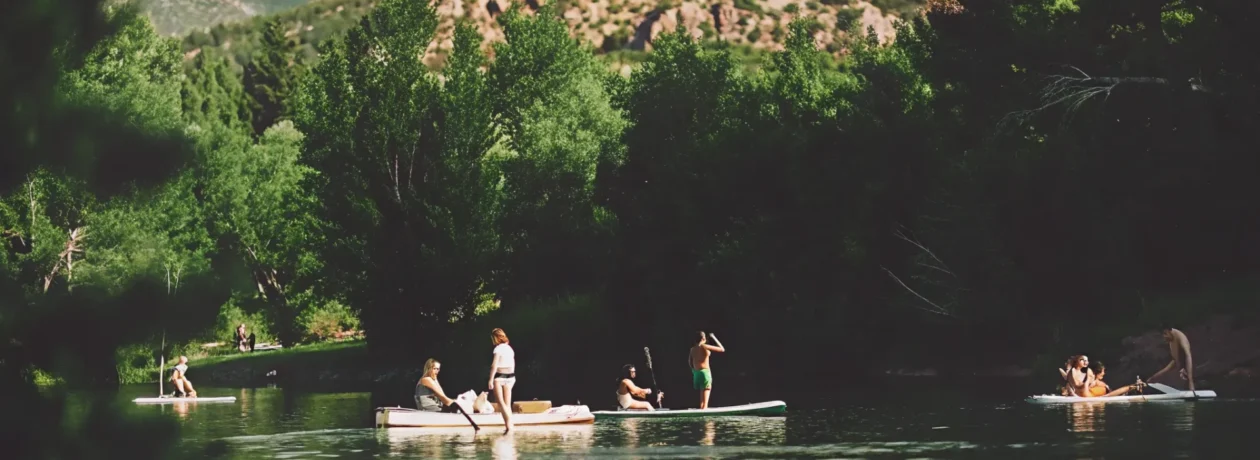 Friends enjoying a pedal boat, kayak, and paddle board on Nottingham Lake