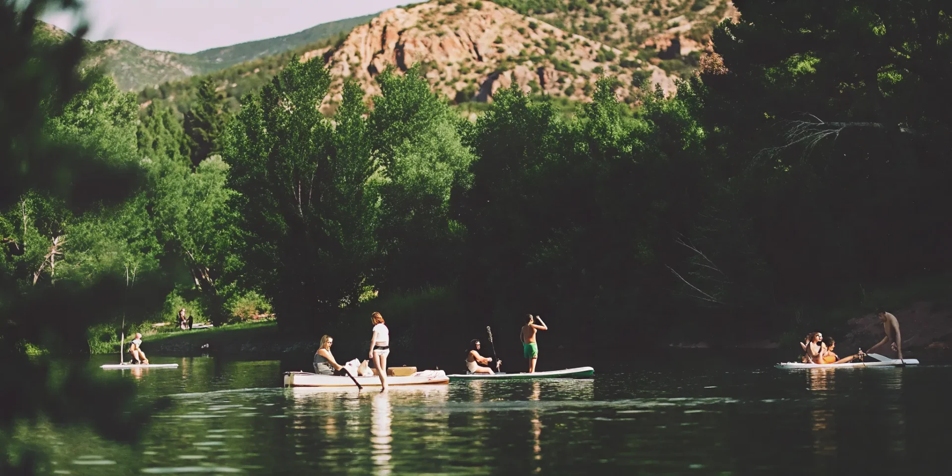 Friends enjoying a pedal boat, kayak, and paddle board on Nottingham Lake