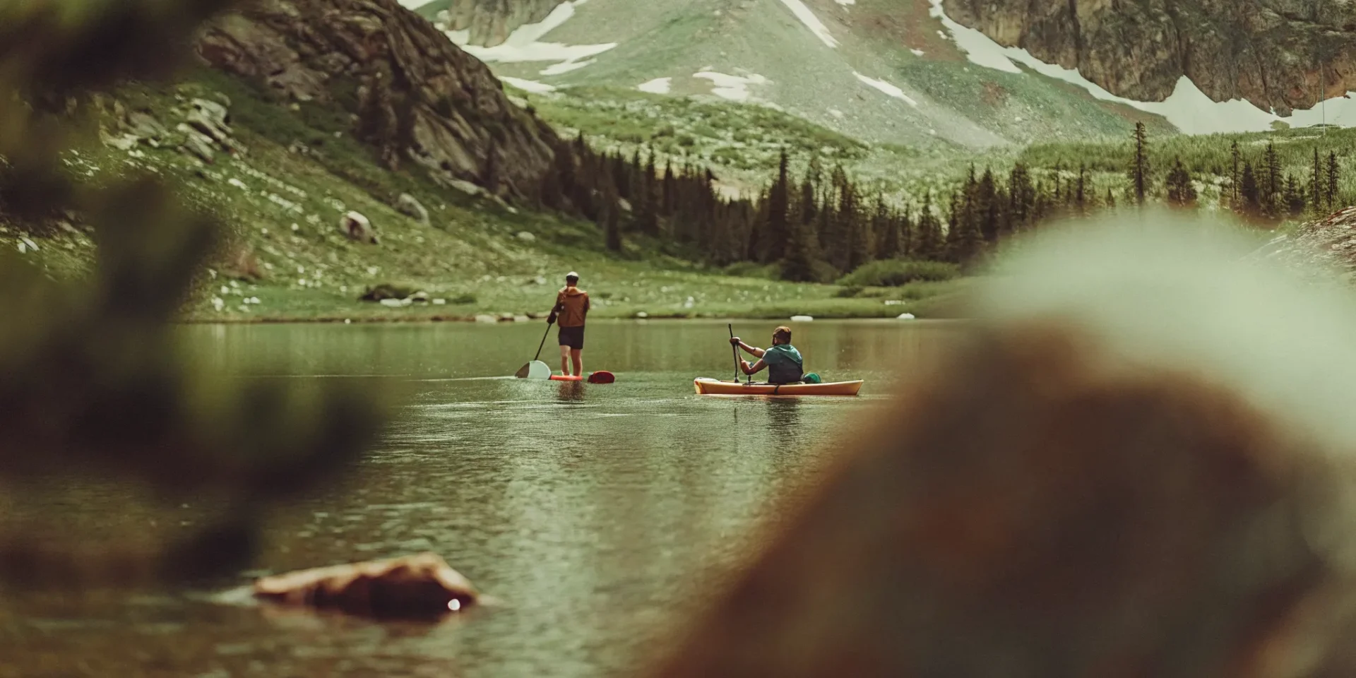 Kayakers and paddle boarders exploring Lake Dillon's alpine coves with Rocky Mountain views