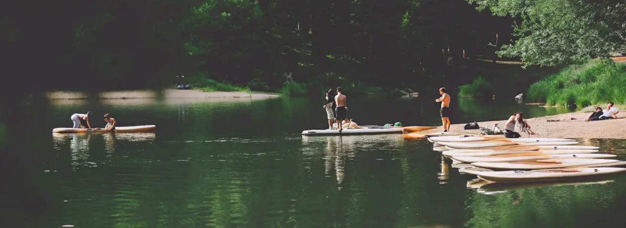 Stand up paddle boarding on calm Nottingham Lake with mountain views in Avon, Colorado