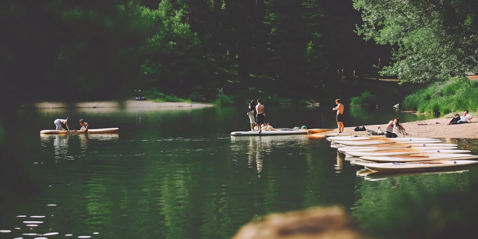Stand up paddle boarding on calm Nottingham Lake with mountain views in Avon, Colorado