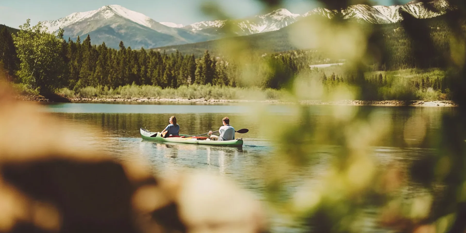 Couple paddling a tandem kayak on Lake Dillon with mountain views